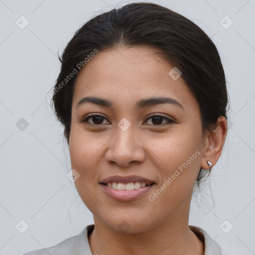 Joyful latino young-adult female with medium  brown hair and brown eyes