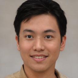 Joyful asian young-adult male with short  brown hair and brown eyes