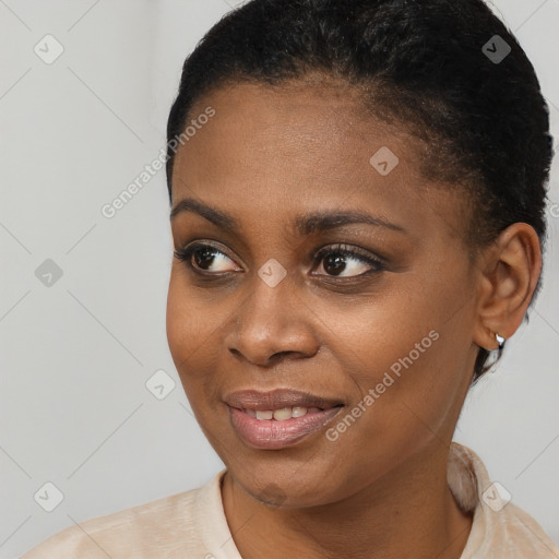 Joyful black young-adult female with short  black hair and brown eyes