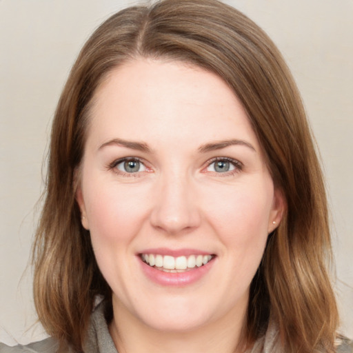 Joyful white young-adult female with medium  brown hair and green eyes