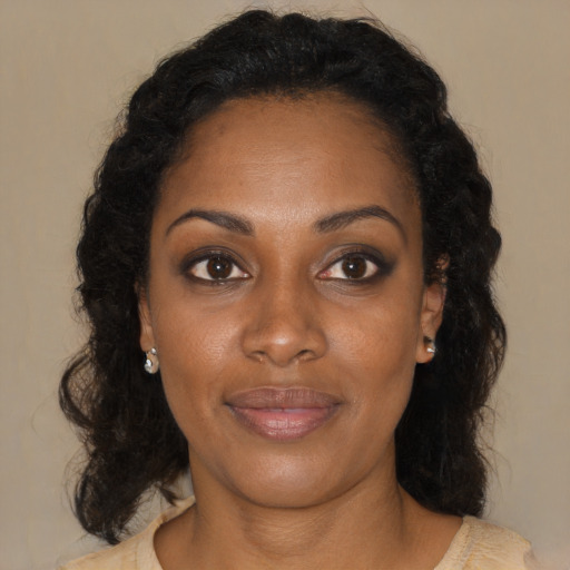 Joyful black young-adult female with medium  brown hair and brown eyes