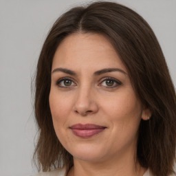 Joyful white young-adult female with medium  brown hair and brown eyes