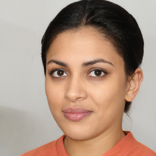 Joyful latino young-adult female with medium  brown hair and brown eyes