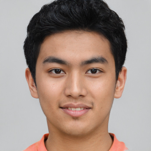 Joyful asian young-adult male with short  black hair and brown eyes