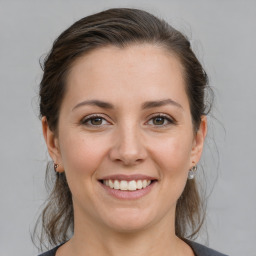 Joyful white young-adult female with medium  brown hair and brown eyes