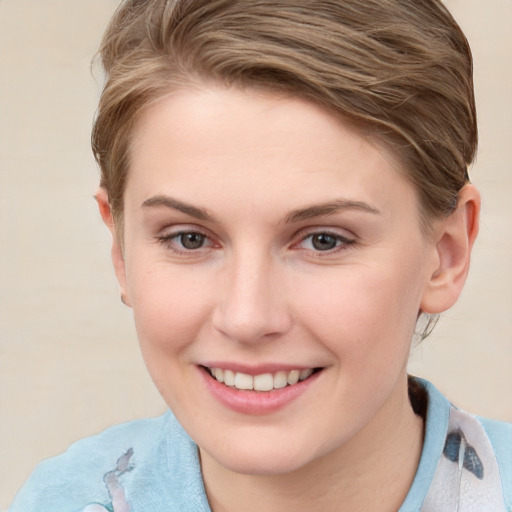 Joyful white young-adult female with short  brown hair and grey eyes