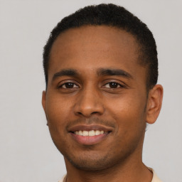 Joyful black young-adult male with short  black hair and brown eyes