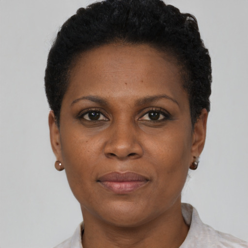 Joyful black adult female with short  brown hair and brown eyes