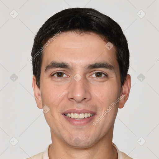 Joyful white young-adult male with short  black hair and brown eyes