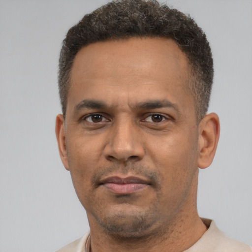 Neutral latino adult male with short  brown hair and brown eyes