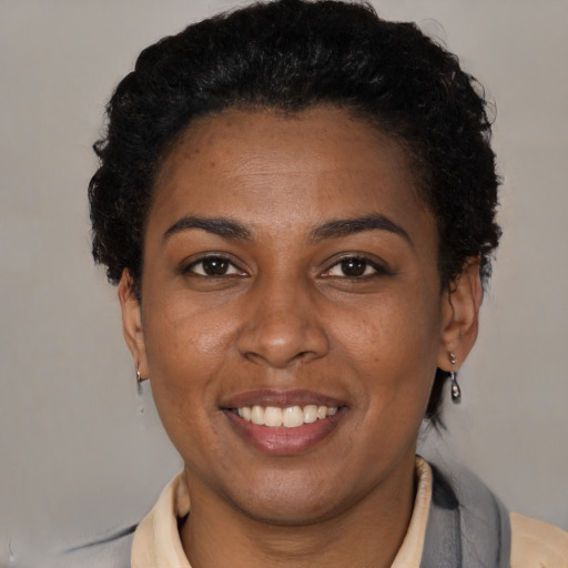 Joyful latino adult female with short  brown hair and brown eyes