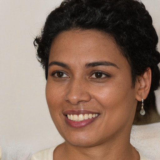 Joyful latino young-adult female with short  brown hair and brown eyes