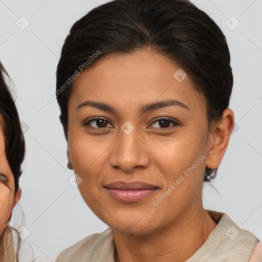 Joyful latino young-adult female with medium  brown hair and brown eyes