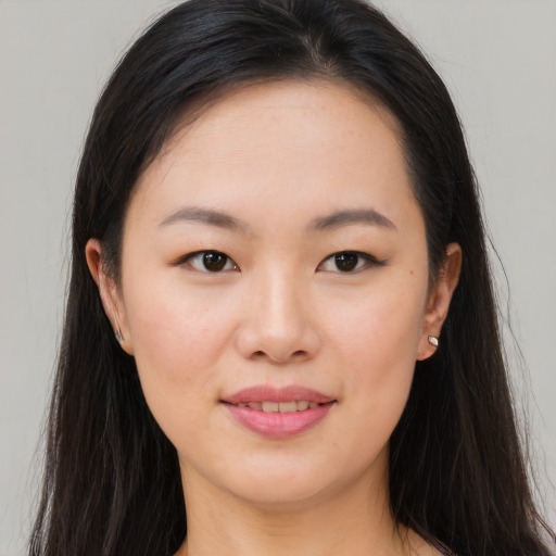 Joyful asian young-adult female with long  brown hair and brown eyes