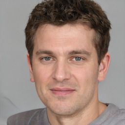 Joyful white adult male with short  brown hair and grey eyes