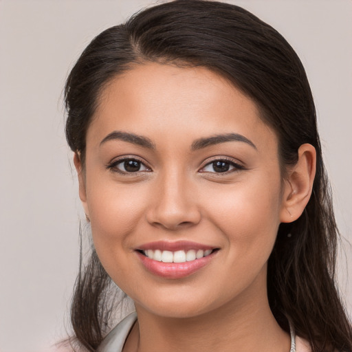 Joyful white young-adult female with long  brown hair and brown eyes