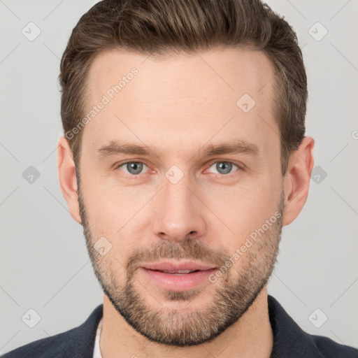 Joyful white young-adult male with short  brown hair and grey eyes