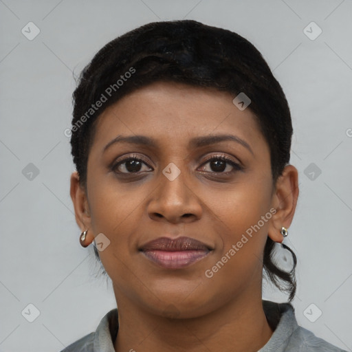 Joyful black young-adult female with short  black hair and brown eyes
