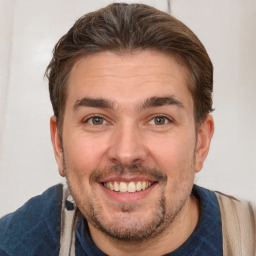 Joyful white adult male with short  brown hair and brown eyes