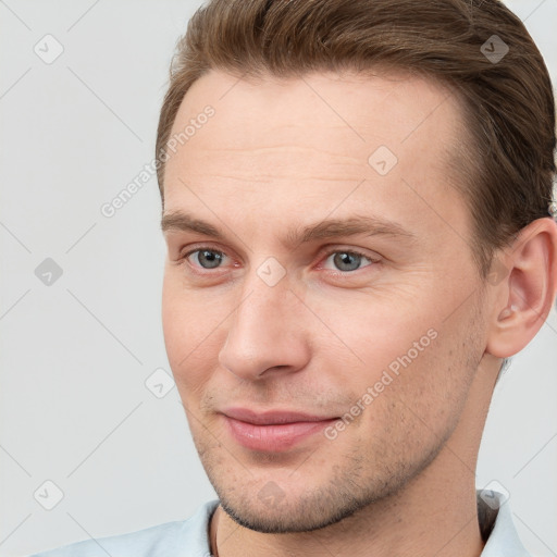 Joyful white young-adult male with short  brown hair and grey eyes