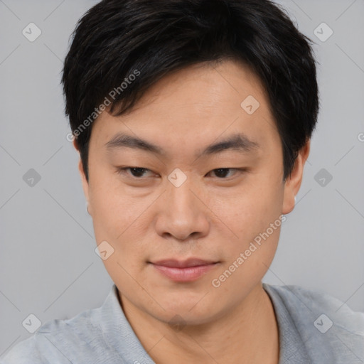 Joyful asian young-adult male with short  black hair and brown eyes