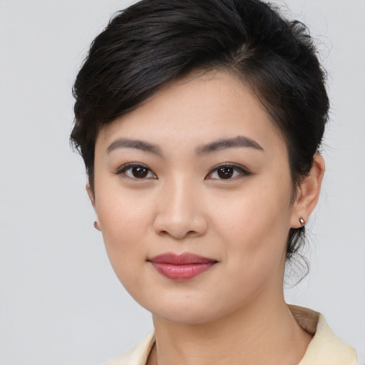 Joyful asian young-adult female with medium  brown hair and brown eyes