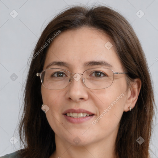 Joyful white adult female with long  brown hair and grey eyes