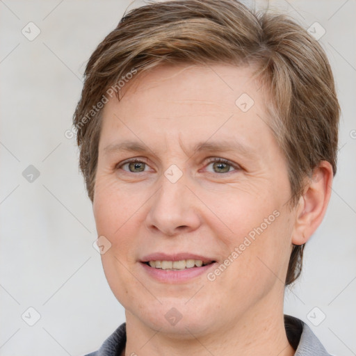 Joyful white adult female with short  brown hair and grey eyes