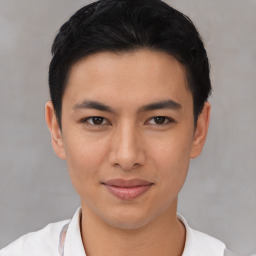 Joyful asian young-adult male with short  black hair and brown eyes