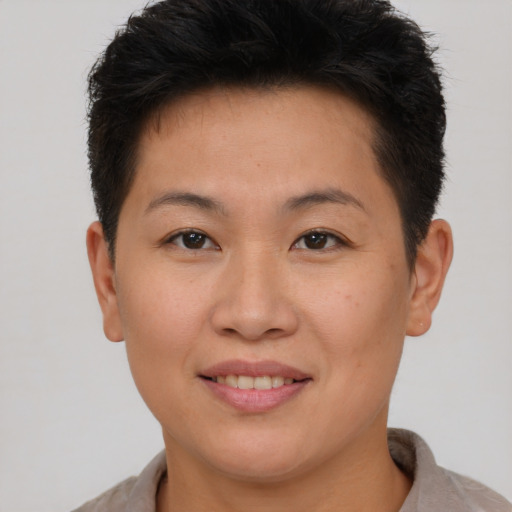 Joyful asian young-adult female with short  brown hair and brown eyes