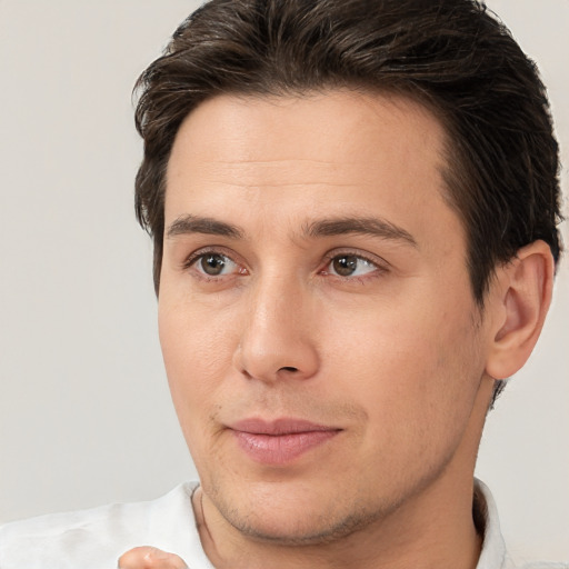 Joyful white young-adult male with short  brown hair and brown eyes