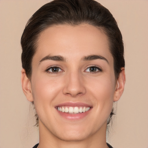 Joyful white young-adult female with medium  brown hair and brown eyes