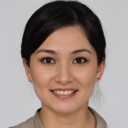 Joyful asian young-adult female with medium  black hair and brown eyes