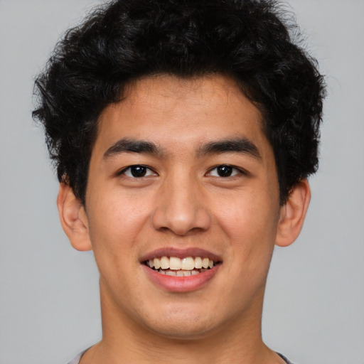 Joyful latino young-adult male with short  brown hair and brown eyes