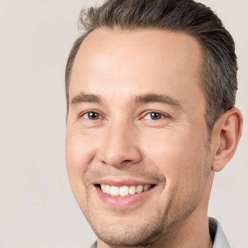 Joyful white adult male with short  brown hair and brown eyes