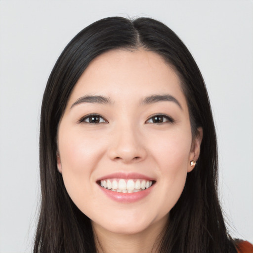 Joyful white young-adult female with long  black hair and brown eyes