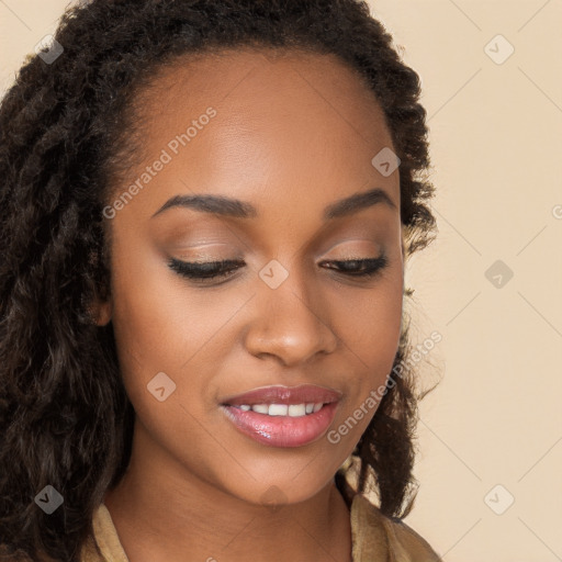 Joyful black young-adult female with long  brown hair and brown eyes