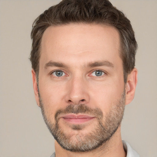 Joyful white adult male with short  brown hair and brown eyes