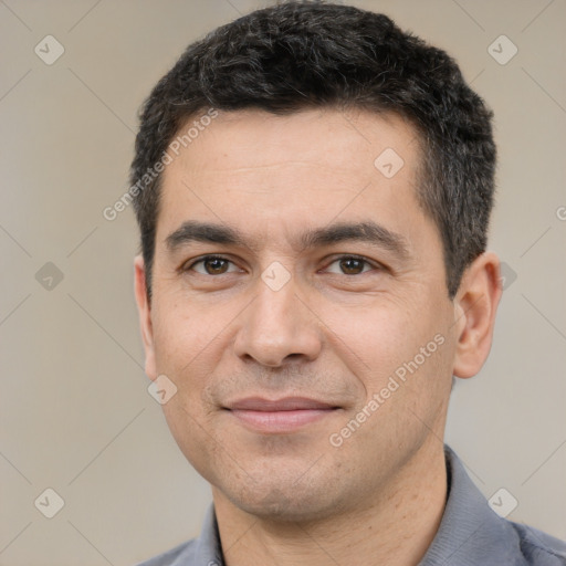 Joyful white young-adult male with short  black hair and brown eyes