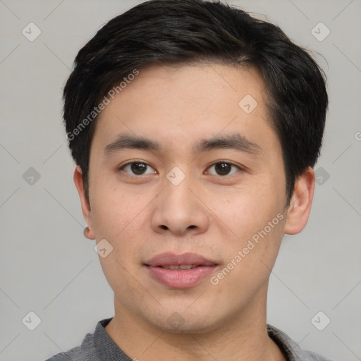 Joyful asian young-adult male with short  black hair and brown eyes