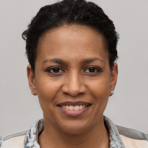 Joyful latino young-adult female with short  black hair and brown eyes