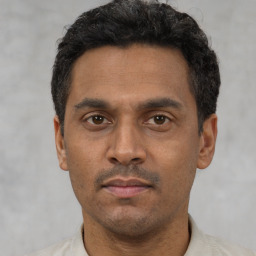 Neutral latino adult male with short  black hair and brown eyes