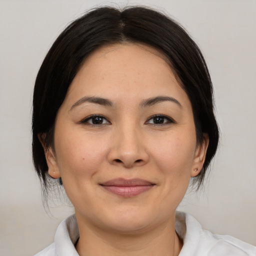 Joyful asian young-adult female with medium  brown hair and brown eyes