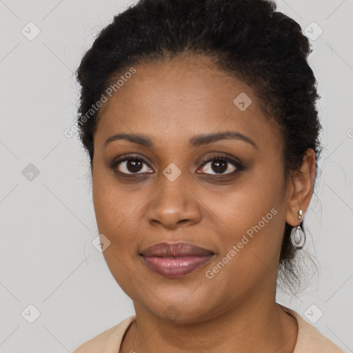 Joyful black young-adult female with long  brown hair and brown eyes