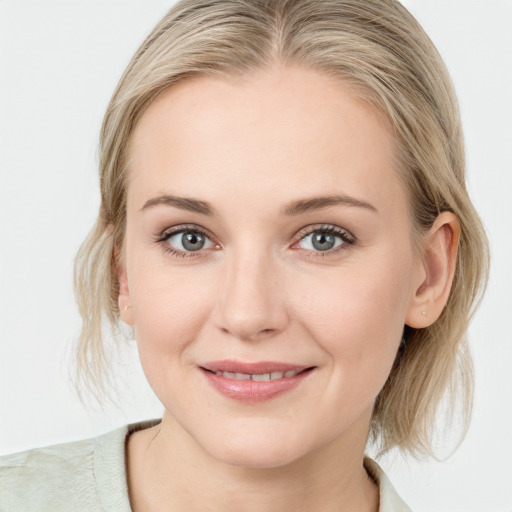 Joyful white young-adult female with medium  brown hair and blue eyes