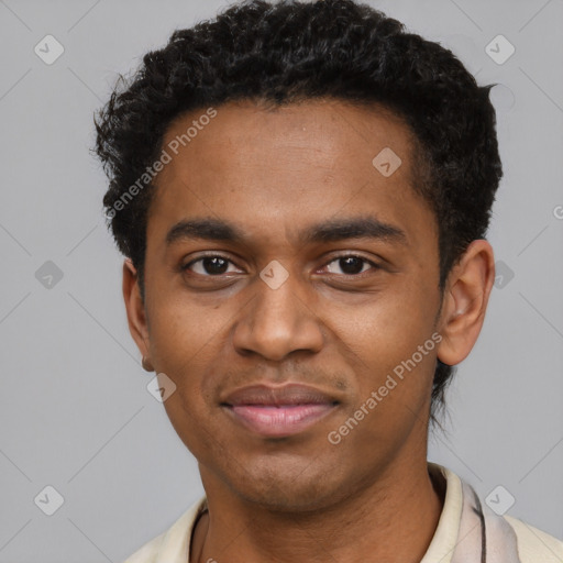 Joyful black young-adult male with short  black hair and brown eyes