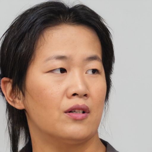 Neutral asian young-adult female with medium  brown hair and brown eyes