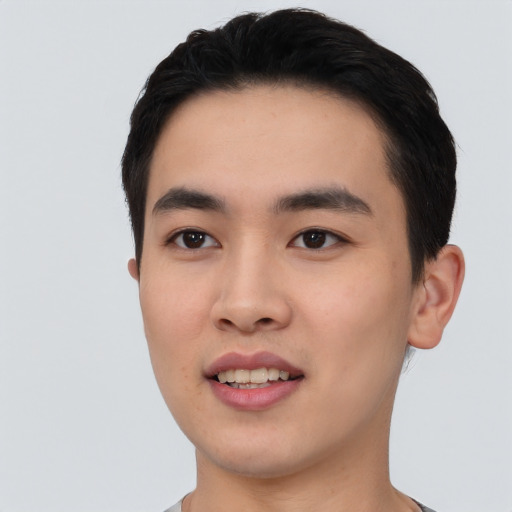 Joyful asian young-adult male with short  black hair and brown eyes