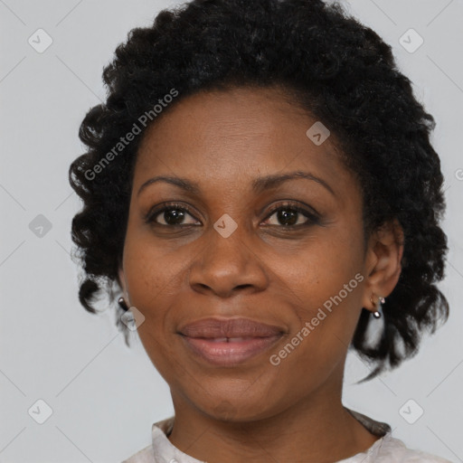 Joyful black adult female with short  brown hair and brown eyes