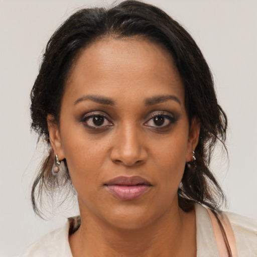 Joyful black young-adult female with medium  brown hair and brown eyes